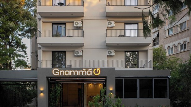 A hotel named "Gnamma 5" with a modern design, multiple balconies, and air conditioning units. - Gnamma Hotel (Palaio Faliro)