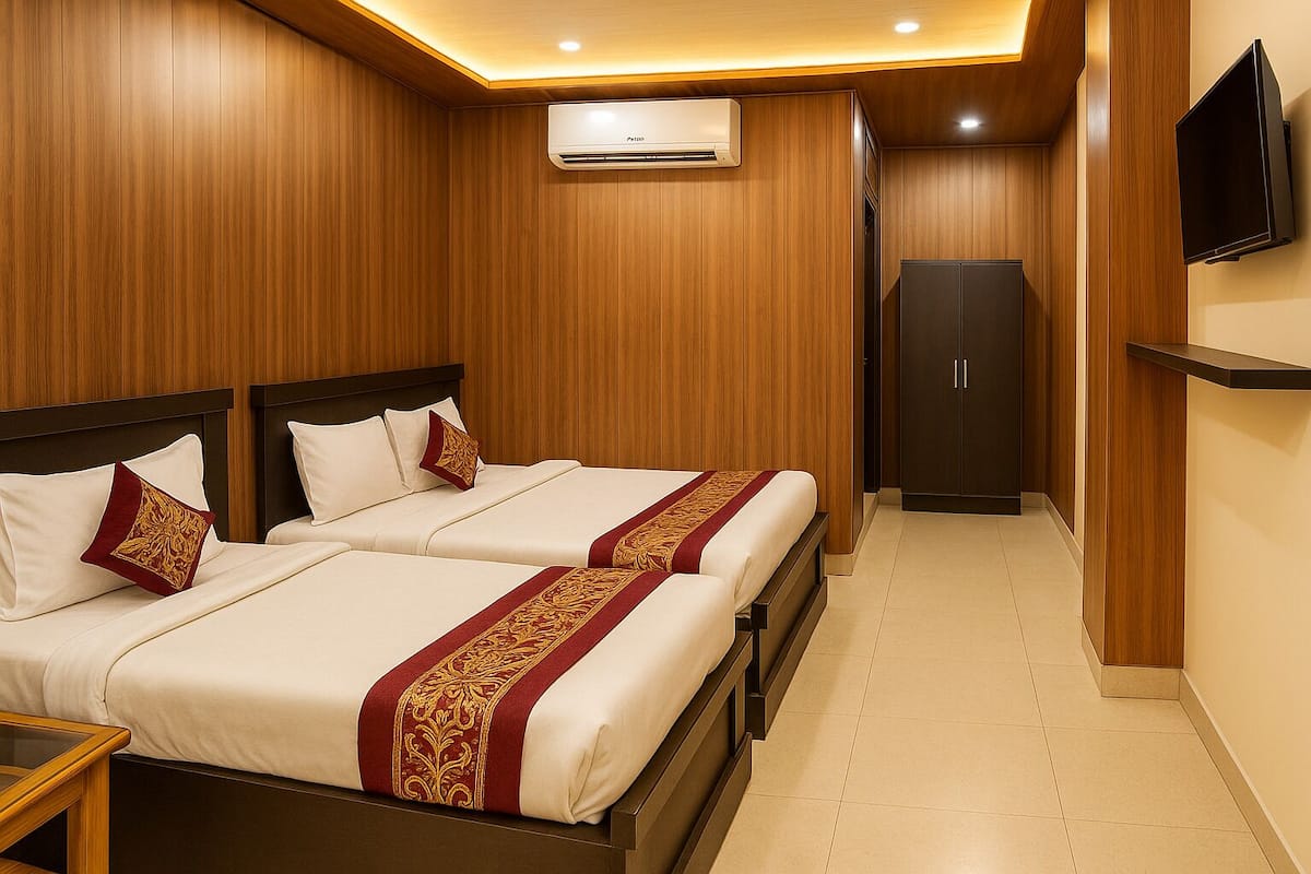 A hotel room with two beds, a wardrobe, a television, and an air conditioning unit.