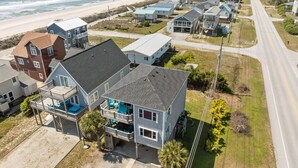 A coastal residential area with houses, a beach, and a road. - Steps to Beach Access, 4 Bedrooms w/ King Suite, Fenced Yard, Pup Friendly (North Topsail Beach)