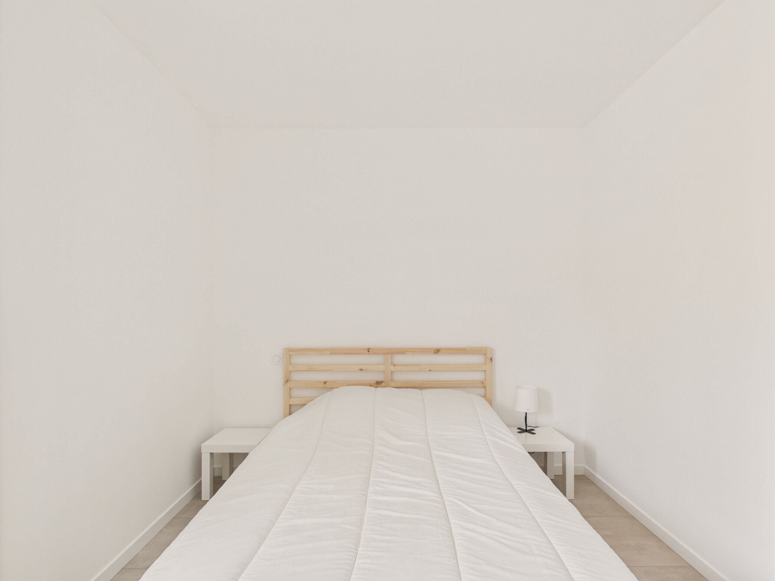 A minimalist bedroom with a single bed, two bedside tables, and a nightstand.