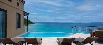 Tropical Island Haven Overlooking Calm Blue Sea Near Dive Sites and Trails