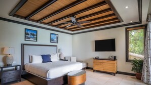 Un dormitorio moderno con una cama grande, techo de madera, televisor de pantalla plana y ventana con persianas.