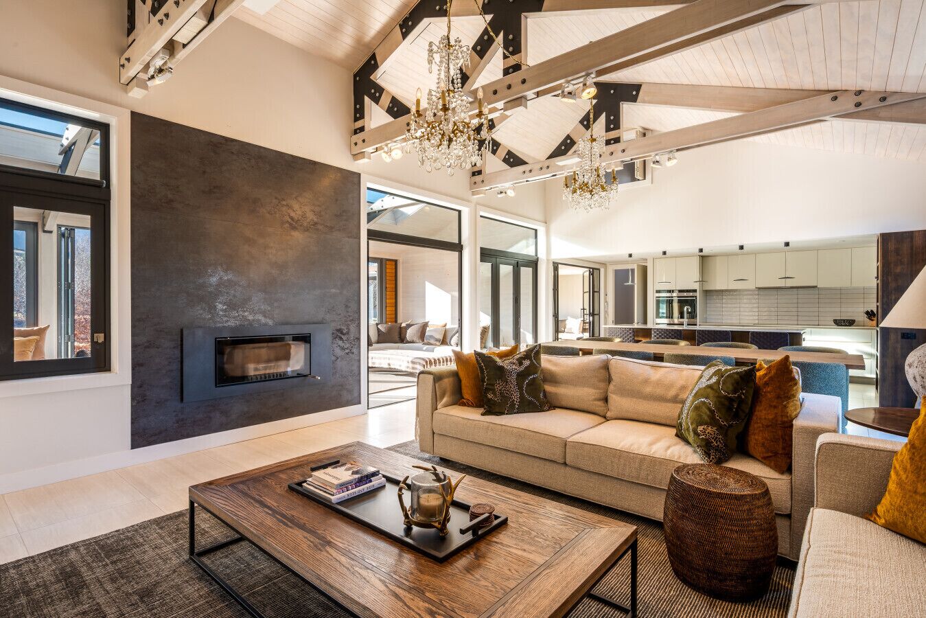 A spacious living area with a modern fireplace, a large sofa set, and a dining area.