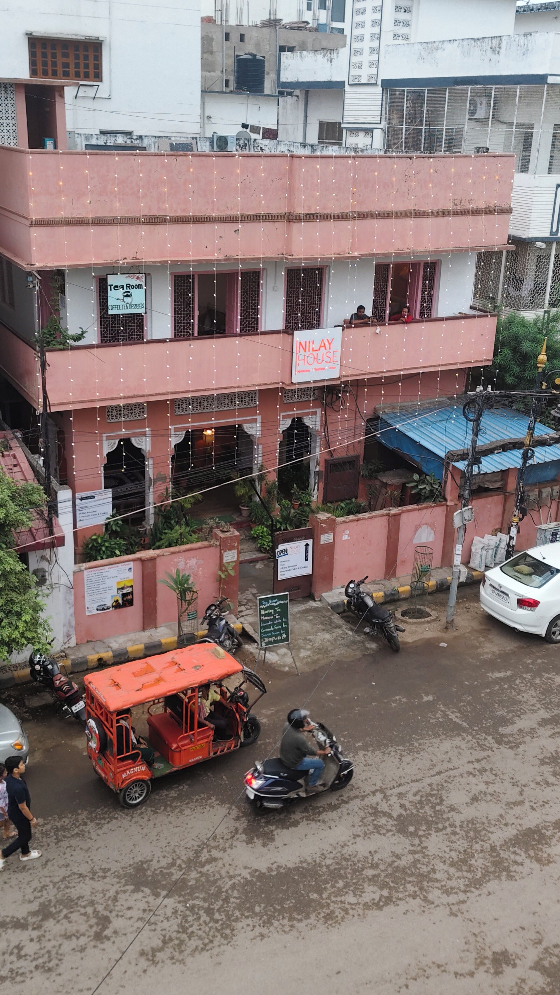 A multi-story building with a sign for a tea room and coffee tea dessert.