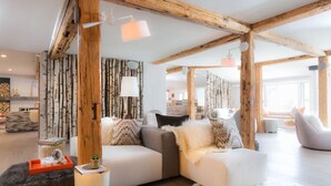 A modern living room with a wooden ceiling, a sofa set, and a fluffy rug. - Enjoy Nature & Town | Stay in Style at Field Guide Lodge, Close to Everything (Stowe)