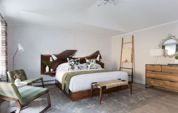 A bedroom with a wooden bed, a chair, a dresser, and a mirror. - Scenic Lodge in Town | Hike, Dine & Relax All Within Walking Distance (Stowe)