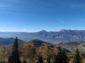 A mountainous landscape with a valley and a small town.
