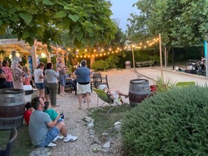 An outdoor gathering area with seating and string lights.
