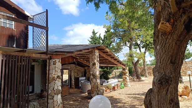 A rustic outdoor patio area with stone pillars, wooden beams, and a covered seating area. - Borgo Incanto (Acquaviva delle Fonti)