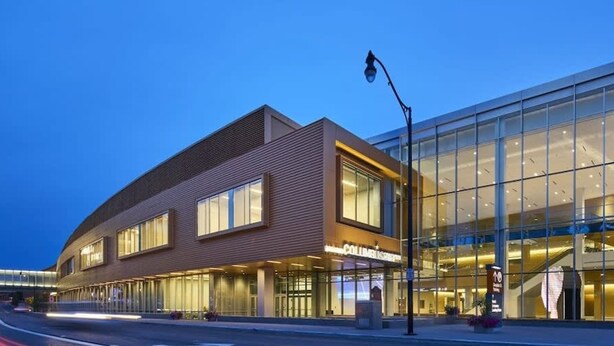 A modern building with a glass facade and a curved entrance. - Prime Location Top Rated Clean Parking Free (Columbus)