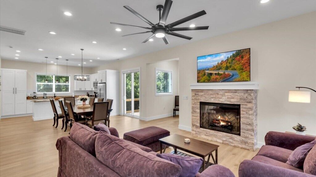 A spacious living area with a fireplace, a dining area, and a kitchen.