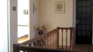 A staircase with wooden railings leading to a landing.