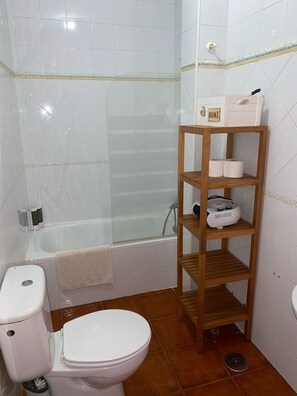 Een haardroger, handdoeken, zeep, toiletpapier