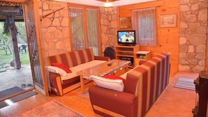 A cozy living room with a sofa, a coffee table, and a television.