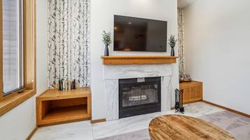 Relaxing Fireplace & TV Area - Kick back with your favorite movie beside the fireplace after skiing, hiking, or exploring Killington.
