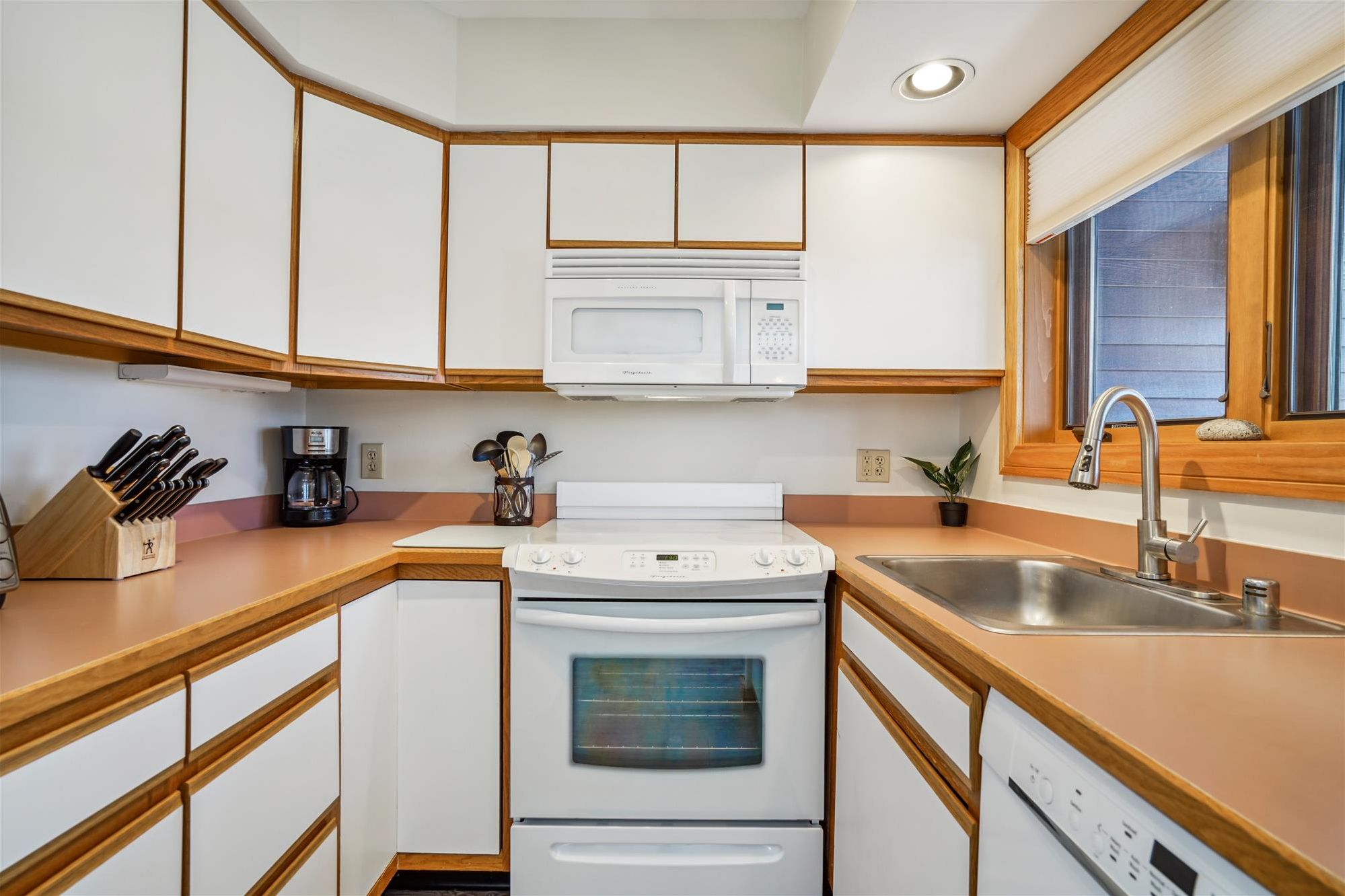 Compact Kitchen with Mountain Condo Charm - The fully equipped kitchen offers full-size appliances, generous counter space, and everything you need to prepare meals during your stay.
