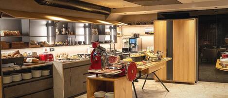 A modern kitchen with a central island, various appliances, and a seating area.