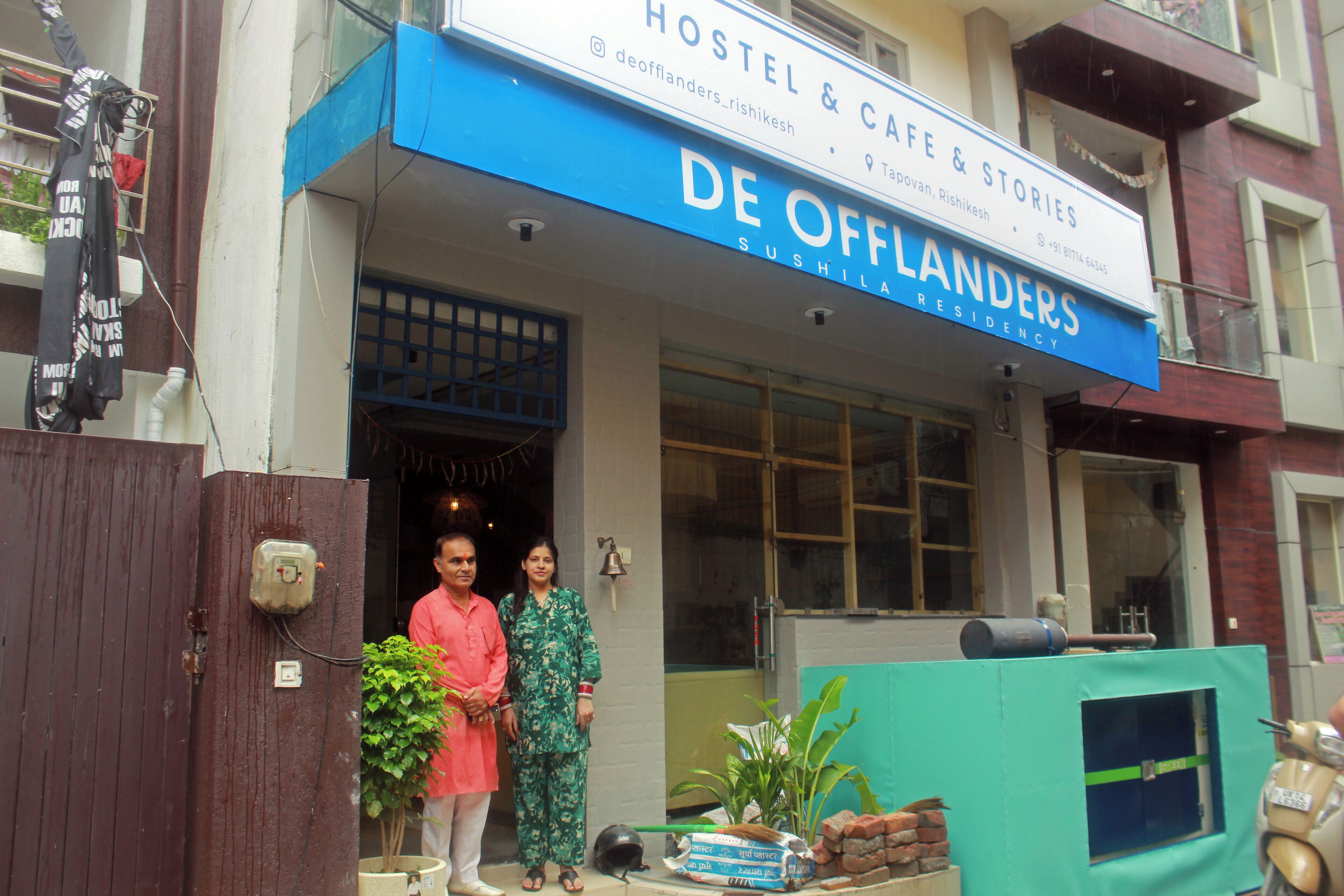 A hostel with a blue signboard reading "DE OFFLANDERS SUSHILANDERS RESIDENCY".