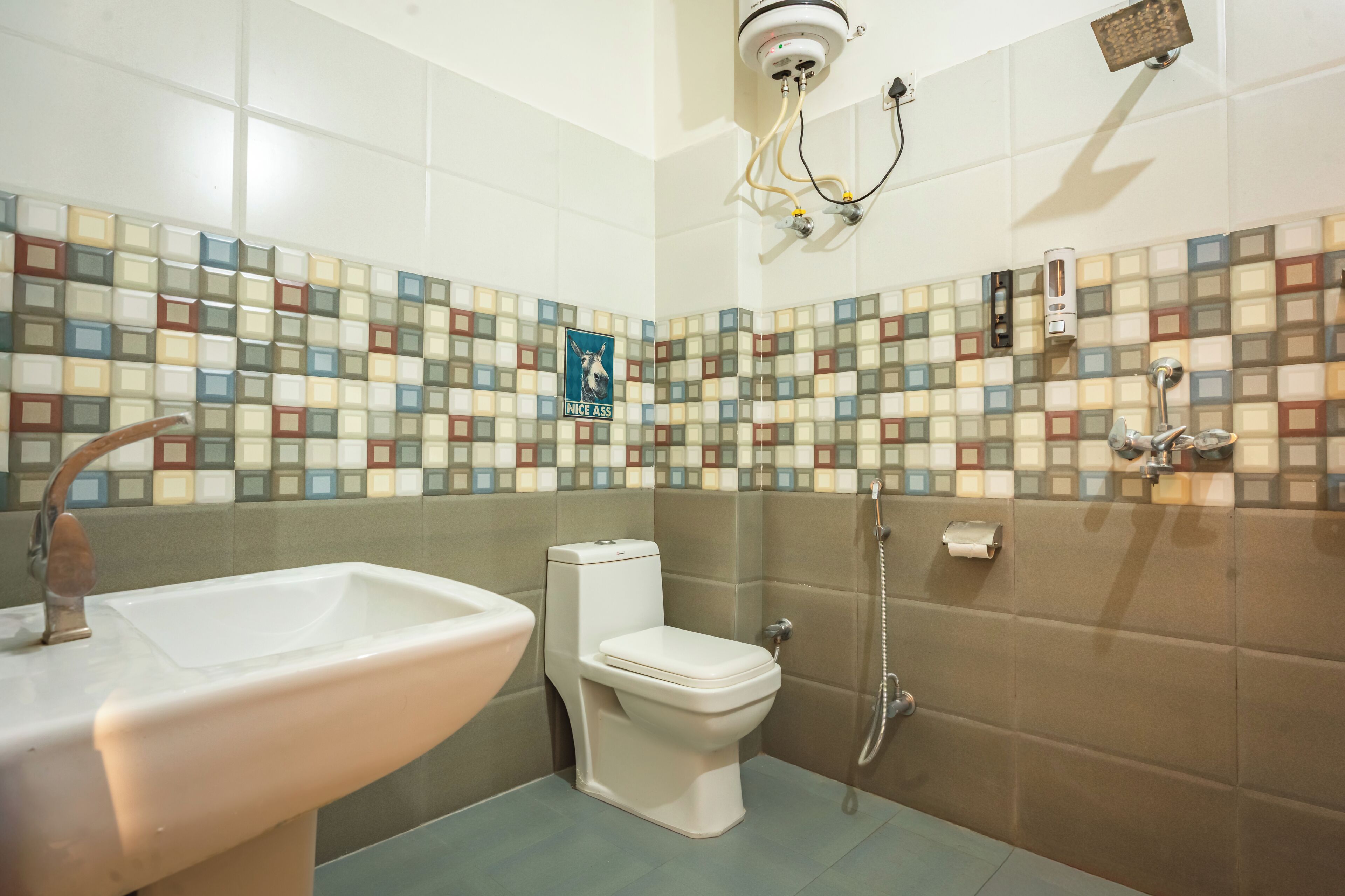 A bathroom with a toilet, sink, and shower.