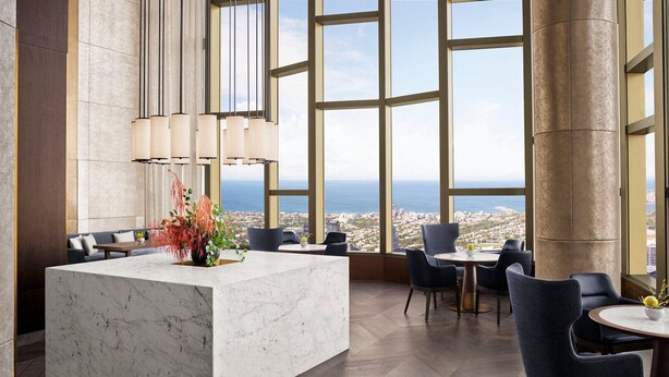 A modern hotel lobby with a marble reception desk, large windows offering a city view, and contemporary seating arrangements. - Designer CBD Executive Suite Heated Pool Gym Sauna (Melbourne)