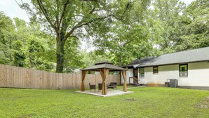 A backyard with a wooden pergola, a covered seating area, and a house with a white exterior. - 5 Mi to Dtwn Atlanta: Family Home w/ Fenced Yard (Atlanta)