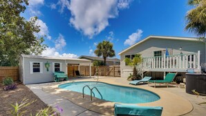 A backyard with a swimming pool, a wooden deck, and a fenced area with lounge chairs. - 2 Blocks to Beach! Family-friendly Home in PCB (Panama City Beach)