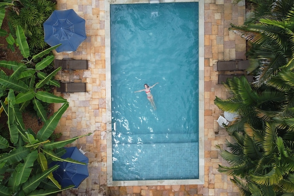 Indoor pool, open 9:00 AM to 9:00 PM, pool umbrellas