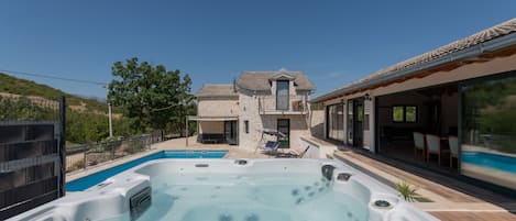 Una casa con piscina y jacuzzi.