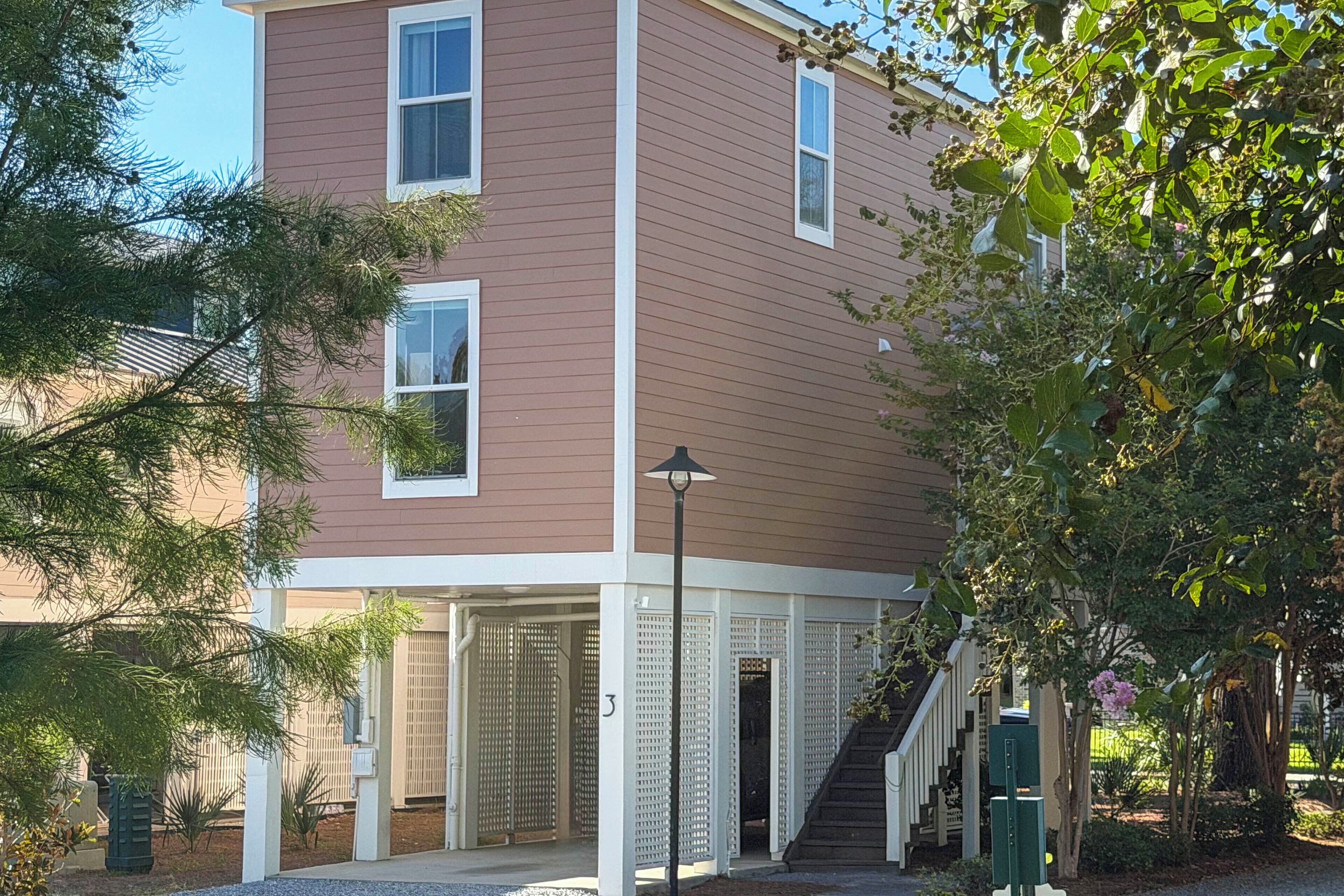 A two-story building with a covered porch and a staircase leading to the entrance.