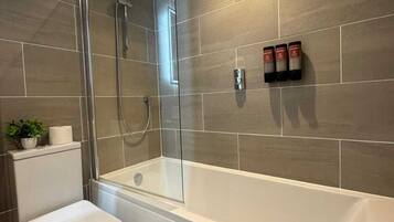 Shower, hair dryer, towels, shampoo