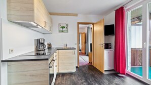 A compact kitchen with wooden cabinets, a coffee maker, and a microwave. - Holiday Apartment '10' with Mountain View, Shared Terrace and Wi-Fi (Todtnau OT Todtnauberg)