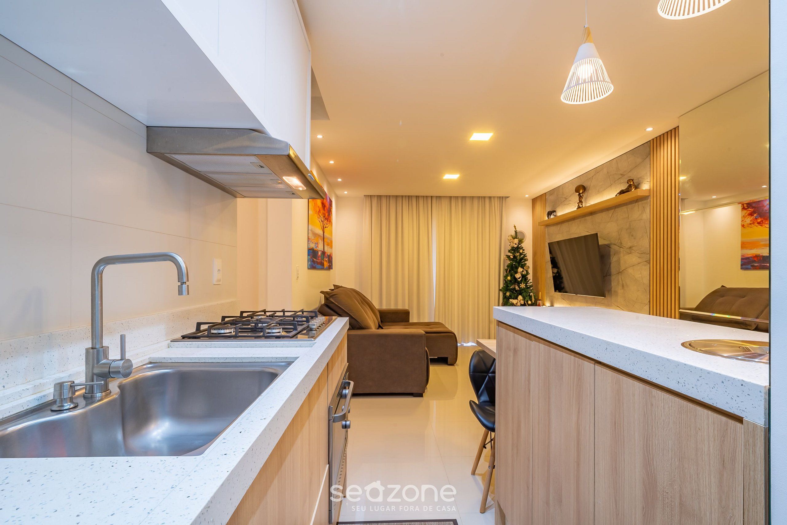 A modern kitchen with a stainless steel sink, a gas stove, and a wooden countertop.