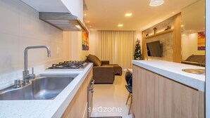 A modern kitchen with a stainless steel sink, a gas stove, and a wooden countertop. - Apt w/ Balcony & BBQ 400m From Beach Dbr0805 (Itapema)