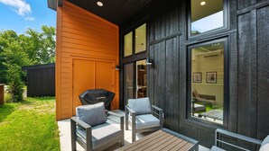 An outdoor patio with a grill, two chairs, and a table. - 500 House - Unit C 1 Bedroom Townhouse (Mequon)
