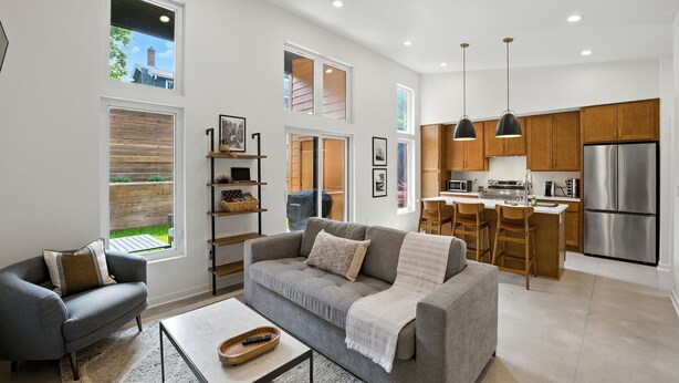 A modern kitchen with a central island, wooden cabinets, and stainless steel appliances. - 500 House - Unit C 1 Bedroom Townhouse (Mequon)