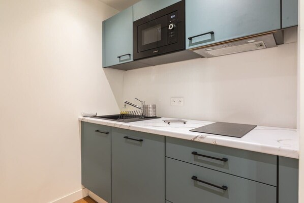 Fridge, microwave, coffee/tea maker, cookware/dishes/utensils