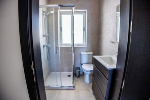 Shower, hair dryer, towels, toilet paper