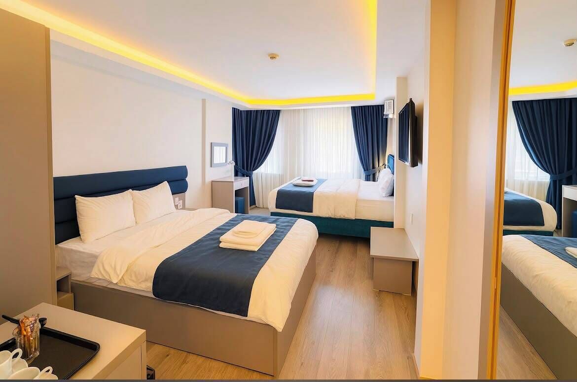 Deluxe Quadruple Room | Minibar, desk, laptop workspace, soundproofing