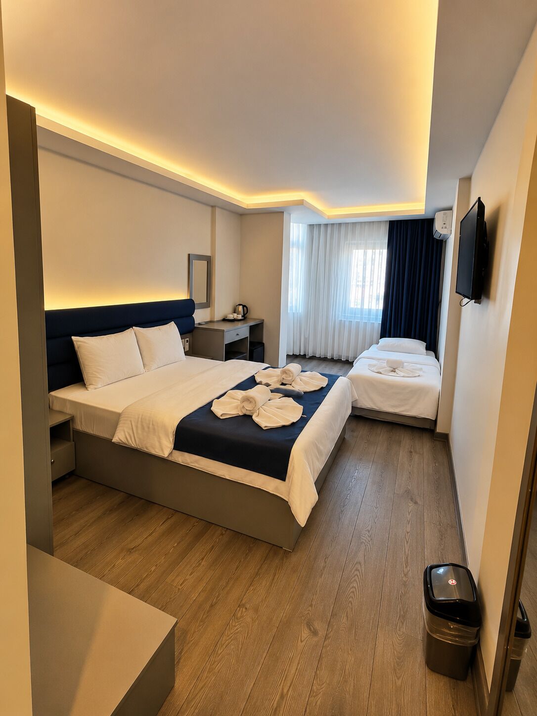 Deluxe Triple Room | Minibar, desk, laptop workspace, soundproofing