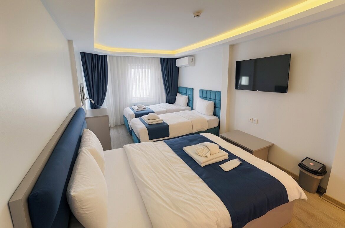 Deluxe Quadruple Room | Minibar, desk, laptop workspace, soundproofing