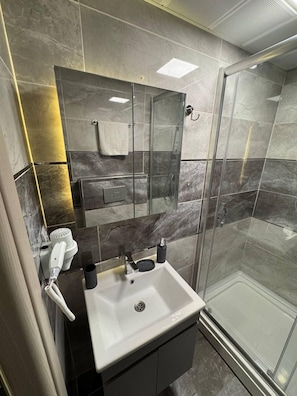 Separate bathtub and shower, hair dryer, towels, soap