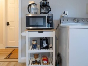 A kitchen with a microwave, toaster, coffee maker, and a stove. - Spacious w Yard + Outdoor +Parking | T Harvard MIT (Somerville)