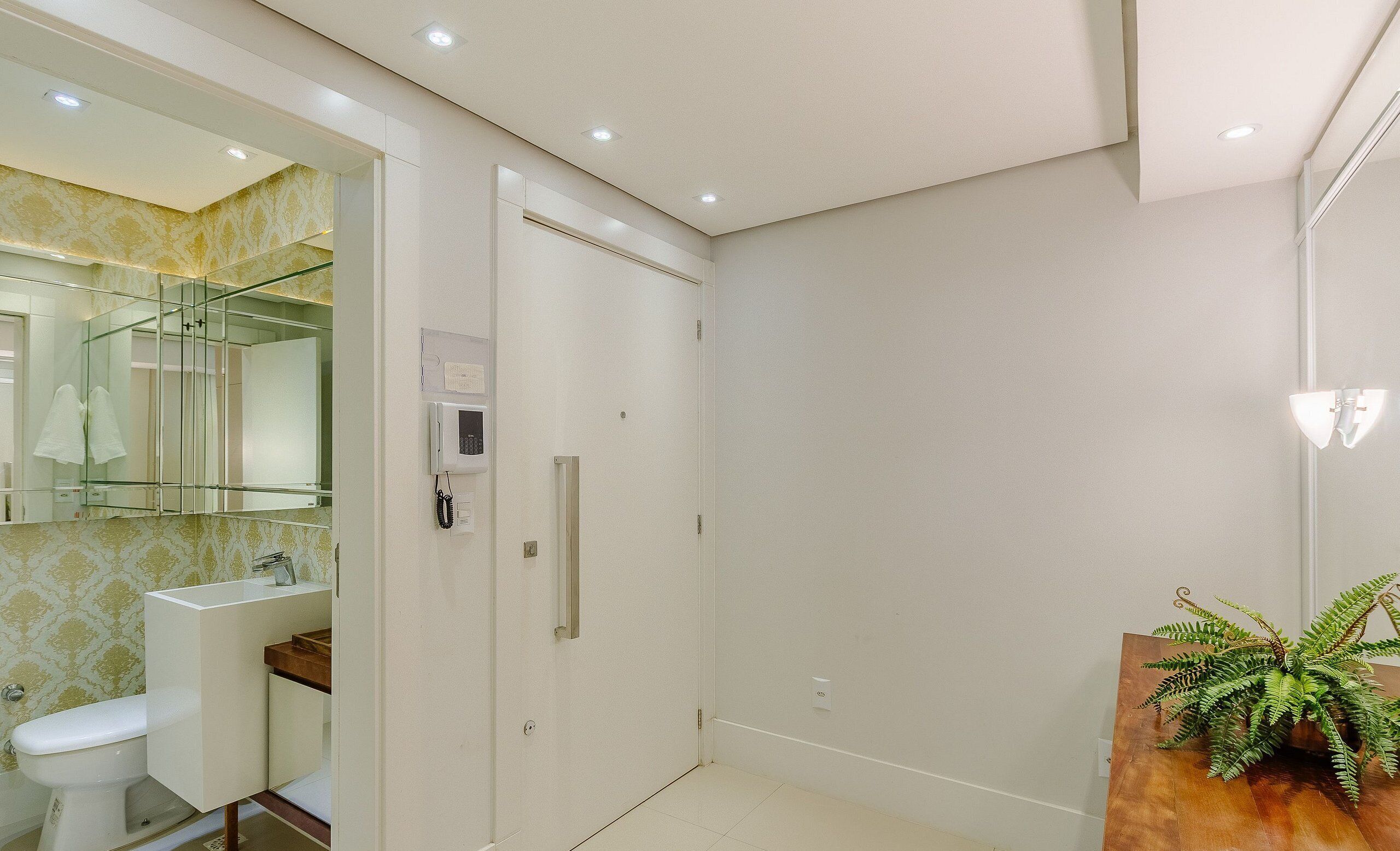 A modern bathroom with a toilet, sink, and a shower area.