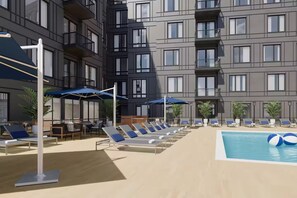 A modern hotel with a rooftop pool, sun loungers, and umbrellas. - Designer 2BR | Gym, Parking (White Plains)
