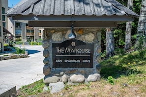 A stone sign with 'The Marquise' and an address. - Big Mauna at the Marquise (Whistler)