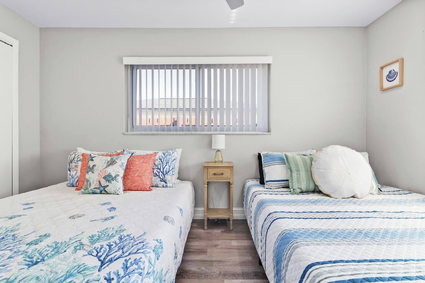 Large secondary bedroom with two queen beds and extra space for relaxation.