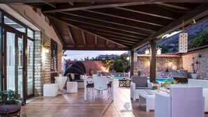 An outdoor patio with stone walls, a pool, and outdoor furniture. - Villa Blondie in Castellammare del Golfo (Castellammare del Golfo)