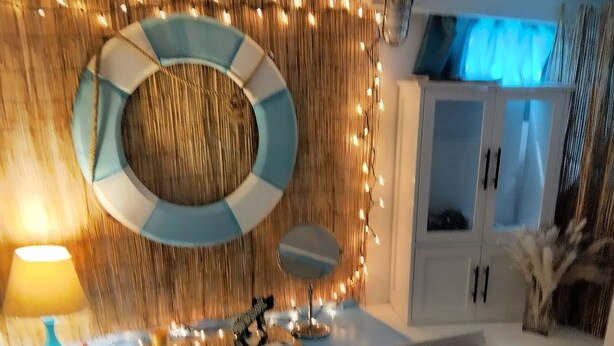 A modern bathroom with a round mirror, a sink, and a bathtub. - Authentic 40' Hatteras Yacht 
Budget Keys Living & Ocean Views  (Key West)