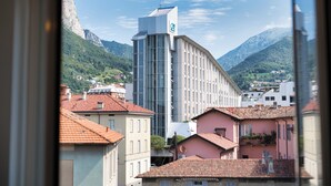 A view of a building with a modern design, surrounded by traditional architecture and mountains in the background. - Royal Suite - Lake Como (Lecco)