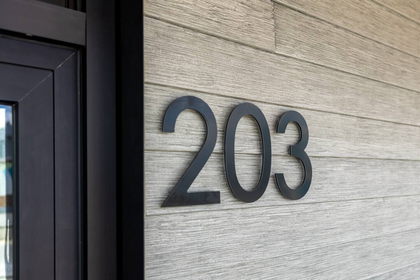 A wall with the number 203, indicating a property or location.